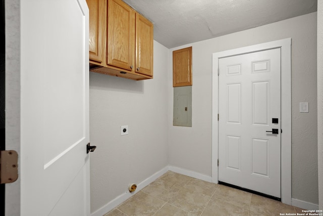 402 Twin Elm, Canyon Lake, TX 78133 - washroom featuring electric dryer hookup, electric panel, cabinet space, baseboards, and light tile patterned flooring