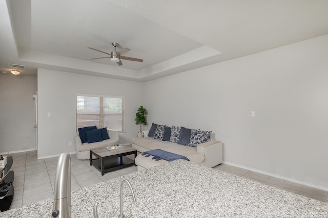121 Buck Holw, San Antonio, TX 78253 - tiled living room featuring ceiling fan, a raised ceiling, and baseboards