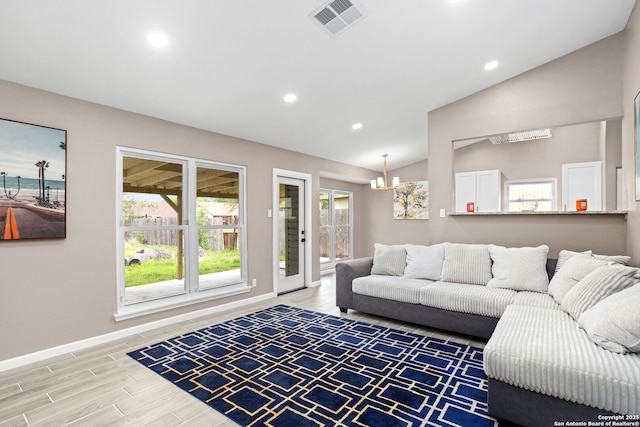 living area with lofted ceiling, recessed lighting, baseboards, light wood-style flooring, and a chandelier