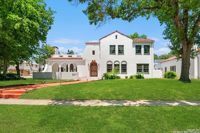 241 W Elsmere, San Antonio, TX 78212 - mediterranean / spanish-style home with a tiled roof, stucco siding, a front yard, and a chimney