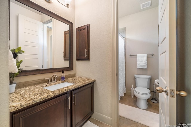 4438 Saddle Spur, San Antonio, TX 78253 - full bathroom with toilet, vanity, a textured wall, baseboards, and tile patterned flooring