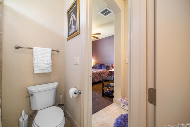4438 Saddle Spur, San Antonio, TX 78253 - ensuite bathroom featuring toilet, tile patterned flooring, a ceiling fan, and baseboards