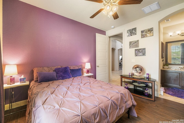 4438 Saddle Spur, San Antonio, TX 78253 - bedroom featuring arched walkways, wood finished floors, ensuite bathroom, and a ceiling fan