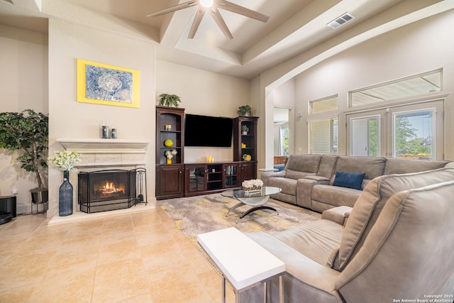 4438 Saddle Spur, San Antonio, TX 78253 - living area featuring ceiling fan, a fireplace, arched walkways, a high ceiling, and tile patterned floors