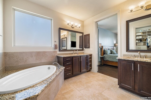 4438 Saddle Spur, San Antonio, TX 78253 - ensuite bathroom with two vanities, a garden tub, and tile patterned floors