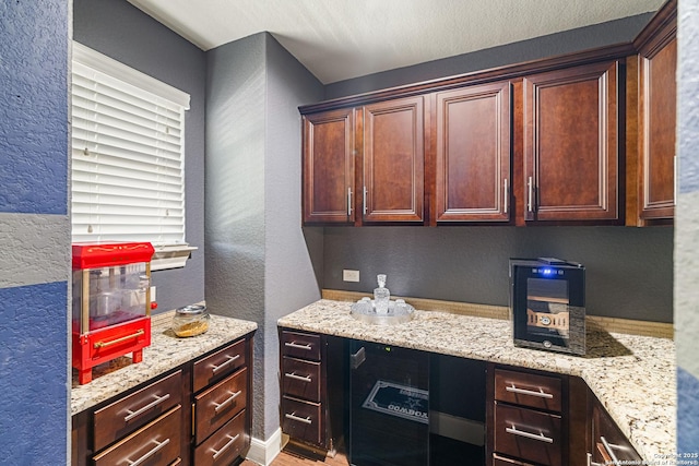 4438 Saddle Spur, San Antonio, TX 78253 - kitchen featuring a textured wall, light stone countertops, and light wood-style flooring