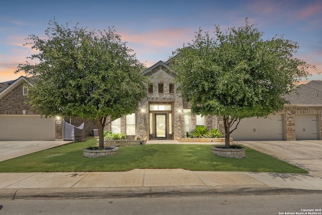 8823 Hideout, San Antonio, TX 78254 - obstructed view of property featuring driveway, a yard, a garage, and brick siding
