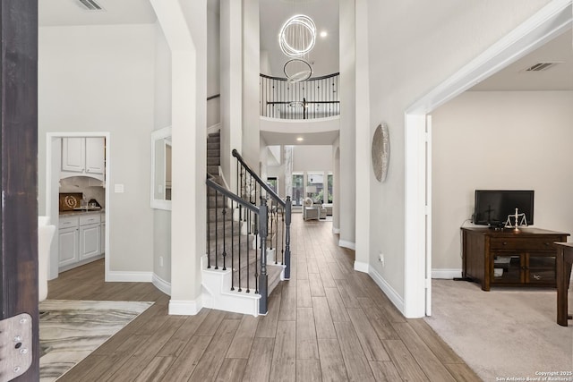 8823 Hideout, San Antonio, TX 78254 - entryway with wood finished floors, stairs, a high ceiling, baseboards, and arched walkways