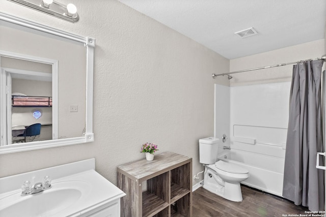 9702 Falcon Bay, Converse, TX 78109 - full bath with vanity, shower / bath combo with shower curtain, toilet, wood finished floors, and a textured wall