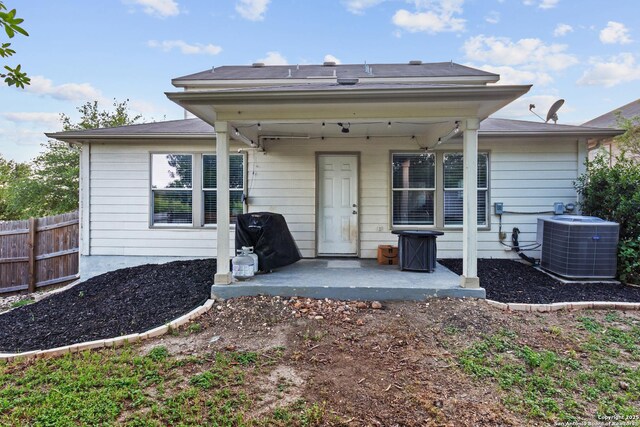 9702 Falcon Bay, Converse, TX 78109 - rear view of house featuring central air condition unit and a patio area