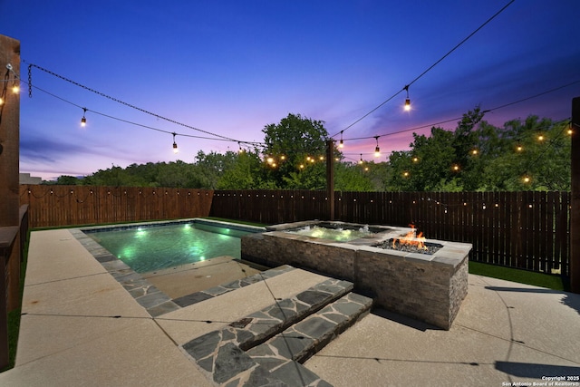 2060 Oedipus, San Antonio, TX 78245 - pool at dusk featuring a fire pit, a patio, a fenced backyard, and a pool with connected hot tub