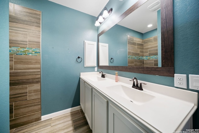 2060 Oedipus, San Antonio, TX 78245 - full bath featuring baseboards, double vanity, and wood finished floors