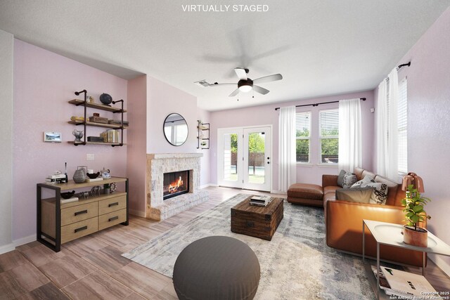 2060 Oedipus, San Antonio, TX 78245 - living room featuring a ceiling fan, a stone fireplace, and baseboards