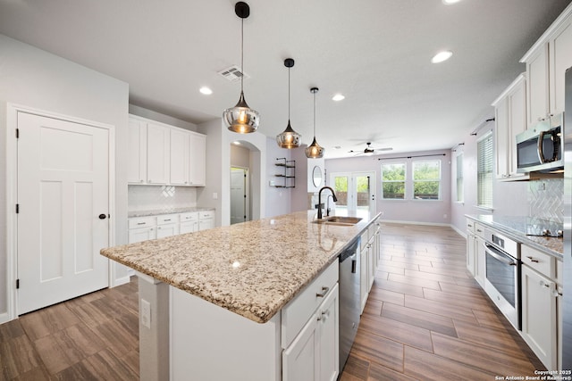 2060 Oedipus, San Antonio, TX 78245 - kitchen featuring appliances with stainless steel finishes, a sink, ceiling fan, recessed lighting, and arched walkways