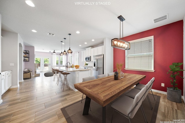 2060 Oedipus, San Antonio, TX 78245 - dining area with recessed lighting, baseboards, light wood-style flooring, and a chandelier
