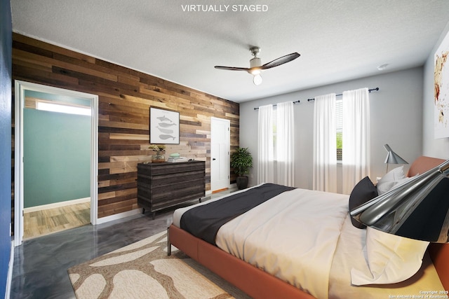 2060 Oedipus, San Antonio, TX 78245 - bedroom with wood walls, ceiling fan, a textured ceiling, and baseboards