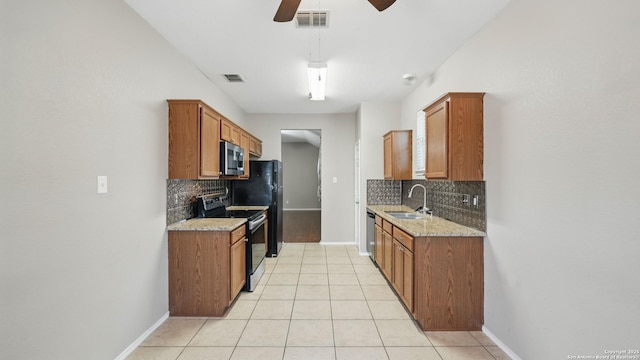 2253 Hidden Mdw, New Braunfels, TX 78130 - kitchen with stainless steel appliances, a sink, backsplash, and light tile patterned floors
