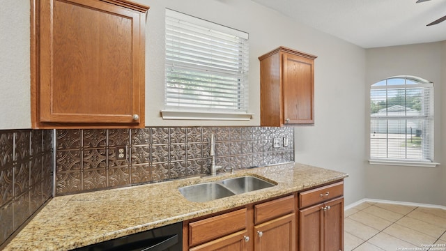 2253 Hidden Mdw, New Braunfels, TX 78130 - kitchen with a sink, tasteful backsplash, light stone counters, and light tile patterned floors