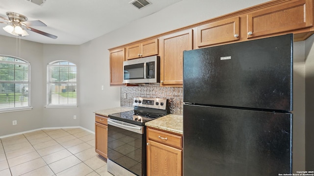 2253 Hidden Mdw, New Braunfels, TX 78130 - kitchen featuring stainless steel appliances, a ceiling fan, decorative backsplash, light tile patterned flooring, and baseboards