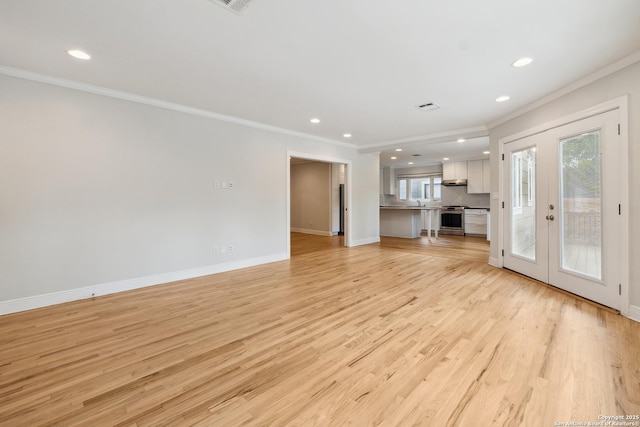 129 Elmview, Alamo Heights, TX 78209 - unfurnished living room with ornamental molding, plenty of natural light, recessed lighting, french doors, and baseboards
