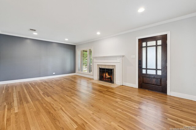 129 Elmview, Alamo Heights, TX 78209 - unfurnished living room featuring ornamental molding, a high end fireplace, light wood-style floors, baseboards, and recessed lighting
