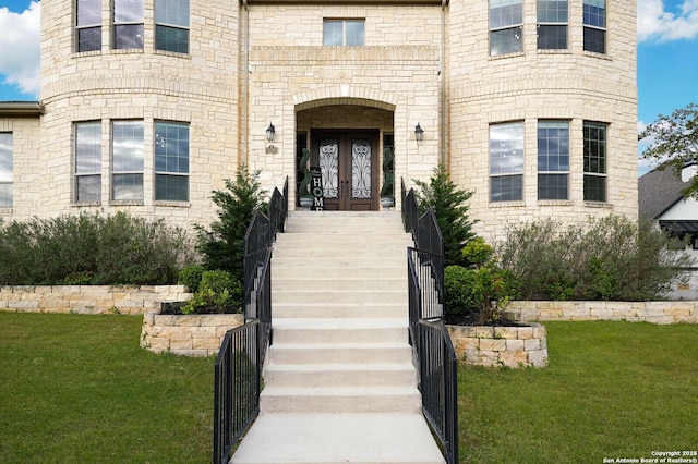 25203 Spider Rock, Boerne, TX 78006 - view of exterior entry with french doors, a yard, and stone siding