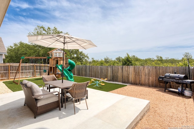 6718 Carlton Crst, San Antonio, TX 78253 - view of patio / terrace featuring a playground, outdoor dining space, a fenced backyard, and grilling area