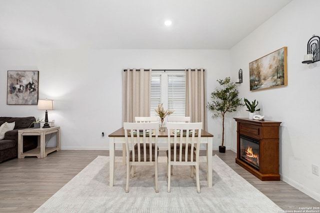 6718 Carlton Crst, San Antonio, TX 78253 - dining room with wood finished floors, baseboards, recessed lighting, and a glass covered fireplace