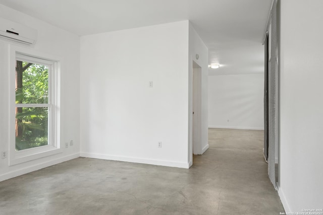 414 Clay Unit 101, & San Antonio, TX 78204 - empty room featuring a wall unit AC, concrete floors, and baseboards