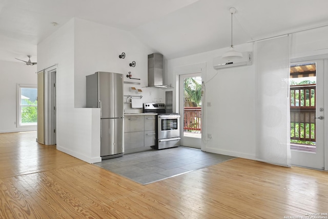 414 Clay Unit 101, & San Antonio, TX 78204 - kitchen featuring stainless steel appliances, wall chimney exhaust hood, a wall mounted air conditioner, healthy amount of natural light, and vaulted ceiling
