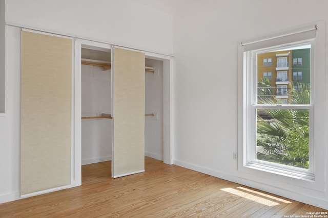 414 Clay Unit 101, & San Antonio, TX 78204 - unfurnished bedroom with wood finished floors, multiple windows, baseboards, and a closet
