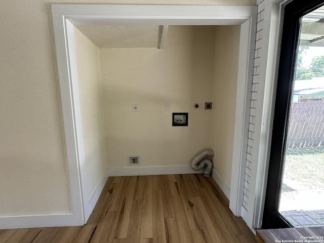 1735 W Hermine Blvd, San Antonio, TX 78201 - laundry area with hookup for an electric dryer, light wood-style flooring, hookup for a washing machine, and baseboards