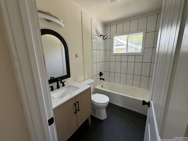 1735 W Hermine Blvd, San Antonio, TX 78201 - full bath with a textured ceiling, toilet, vanity, tub / shower combination, and tile patterned flooring