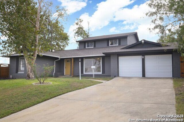 4615 Golf Vw, San Antonio, TX 78223 - traditional-style home with an attached garage, concrete driveway, and a front yard