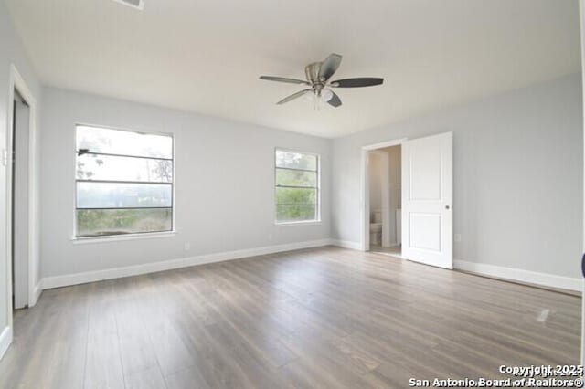 4615 Golf Vw, San Antonio, TX 78223 - unfurnished bedroom with wood finished floors, baseboards, and ceiling fan
