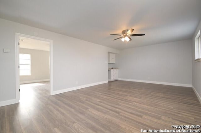4615 Golf Vw, San Antonio, TX 78223 - unfurnished living room with a ceiling fan, wood finished floors, and baseboards