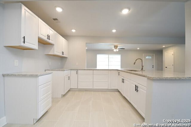 4615 Golf Vw, San Antonio, TX 78223 - kitchen with a sink, a ceiling fan, light stone countertops, white cabinets, and recessed lighting