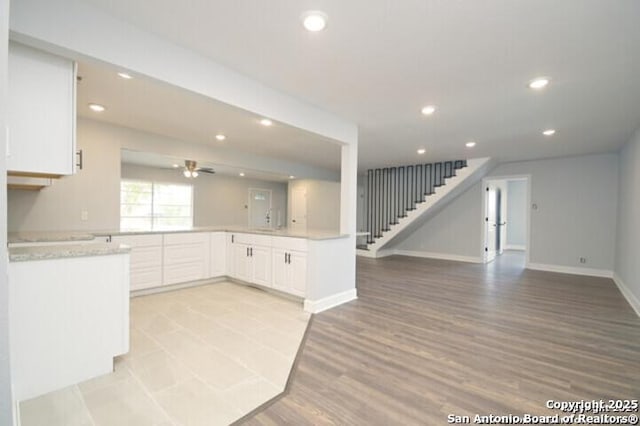 4615 Golf Vw, San Antonio, TX 78223 - kitchen with open floor plan, white cabinetry, baseboards, recessed lighting, and light countertops