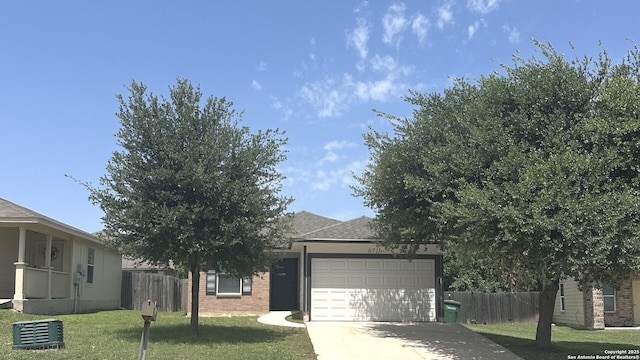 6711 Dragon Tooth, San Antonio, TX 78242 - obstructed view of property with a garage, concrete driveway, and brick siding