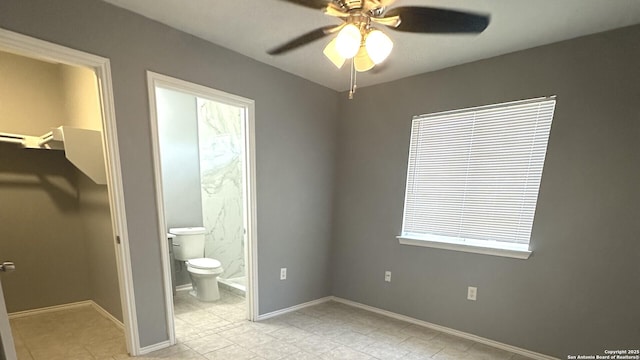 6711 Dragon Tooth, San Antonio, TX 78242 - unfurnished bedroom featuring light tile patterned flooring, connected bathroom, baseboards, and ceiling fan