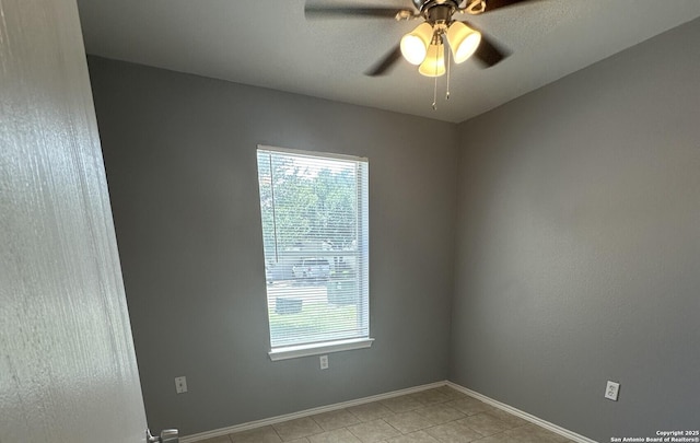 6711 Dragon Tooth, San Antonio, TX 78242 - empty room featuring healthy amount of natural light, a ceiling fan, light tile patterned floors, and baseboards