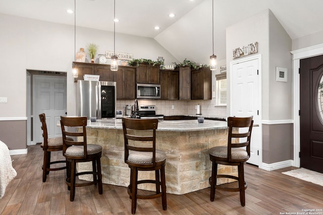 184 Great Oaks Ln, Vernia, TX 78121 - kitchen featuring appliances with stainless steel finishes, dark brown cabinetry, baseboards, decorative backsplash, and high vaulted ceiling
