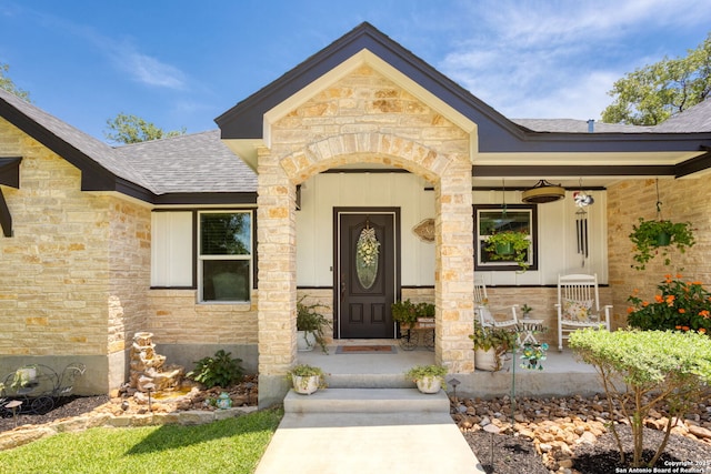 184 Great Oaks Ln, Vernia, TX 78121 - entrance to property featuring stone siding, a shingled roof, and a porch