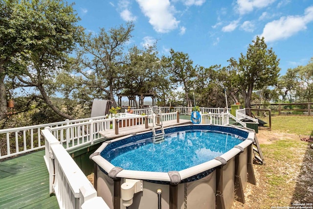 573 Mountain Oaks Dr, Canyon Lake, TX 78133 - view of swimming pool featuring a deck, a hot tub, and fence