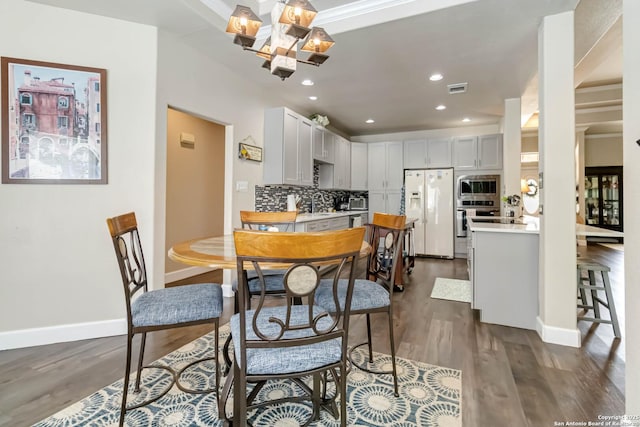573 Mountain Oaks Dr, Canyon Lake, TX 78133 - dining room with dark wood-style flooring, baseboards, recessed lighting, and a chandelier