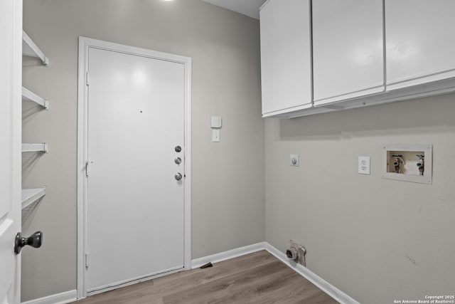 25233 Battle Lk, San Antonio, TX 78260 - laundry room with hookup for an electric dryer, hookup for a washing machine, wood finished floors, baseboards, and cabinet space