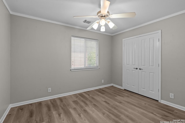 25233 Battle Lk, San Antonio, TX 78260 - unfurnished bedroom with crown molding, wood finished floors, baseboards, a closet, and a ceiling fan