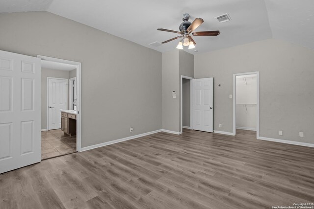 25233 Battle Lk, San Antonio, TX 78260 - unfurnished bedroom with lofted ceiling, wood finished floors, ensuite bathroom, baseboards, and a ceiling fan