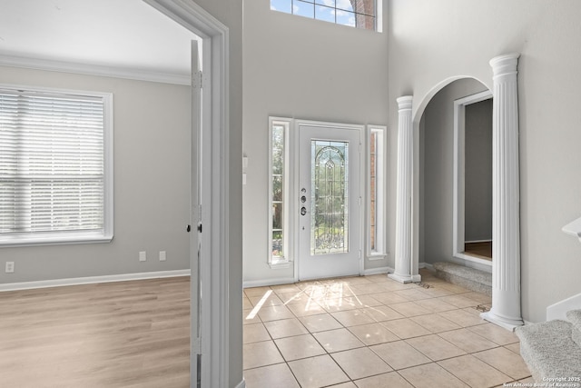25233 Battle Lk, San Antonio, TX 78260 - entryway featuring decorative columns, healthy amount of natural light, arched walkways, and crown molding