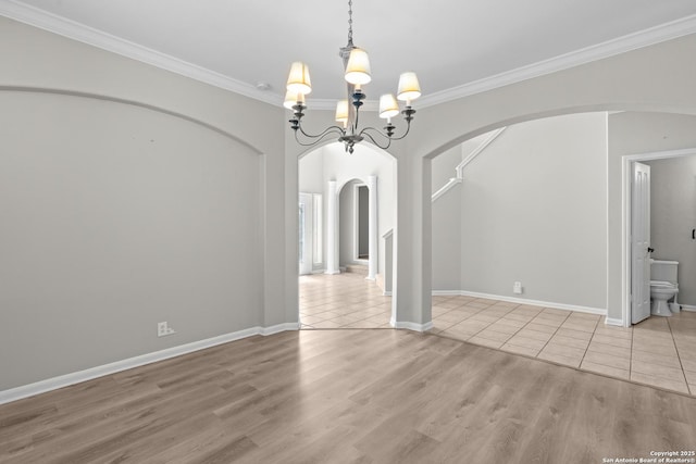 25233 Battle Lk, San Antonio, TX 78260 - spare room with arched walkways, a chandelier, wood finished floors, crown molding, and baseboards